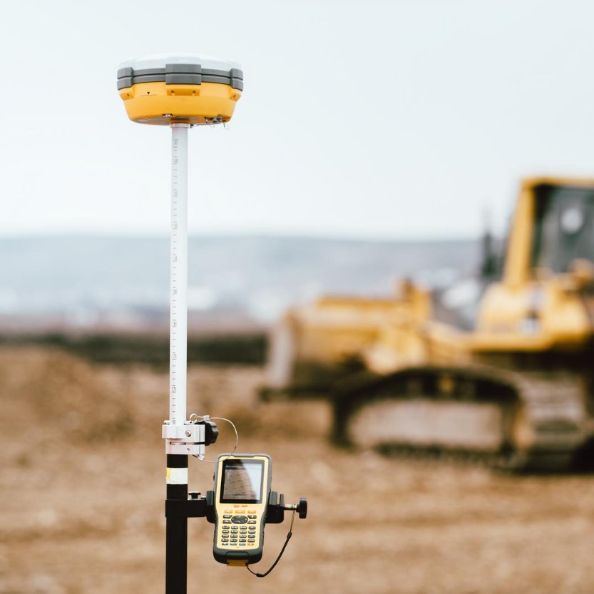 GNSS rover on a survey pole at a construction site